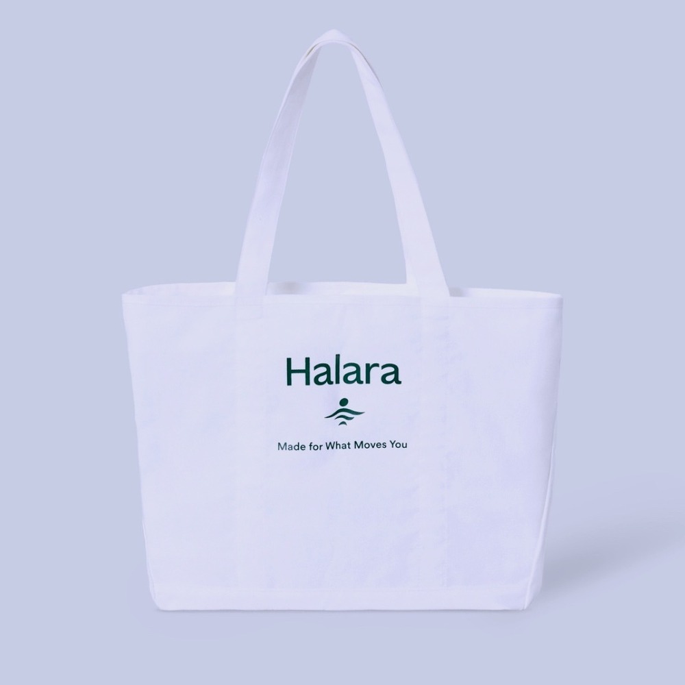 Women's white Halara canvas tote bag with a green logo and text NWT travel gym